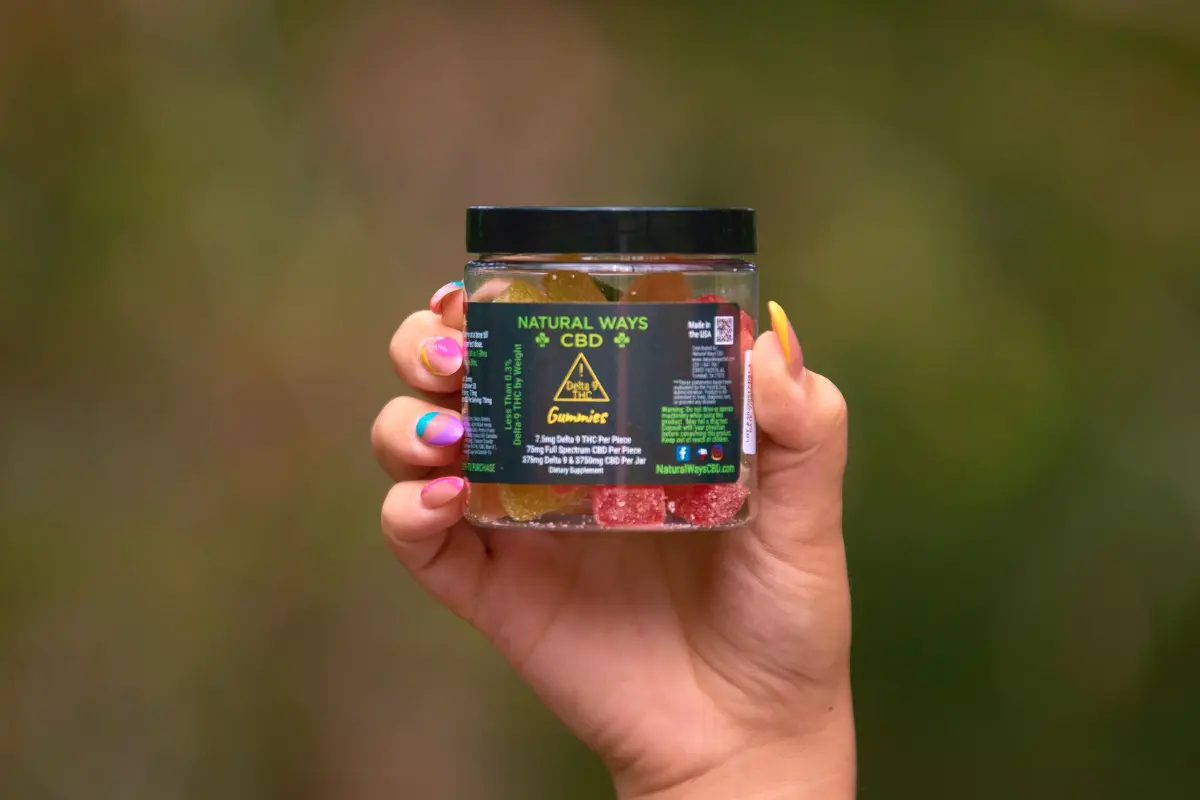 Woman holding natural ways CBD delta 9 gummies