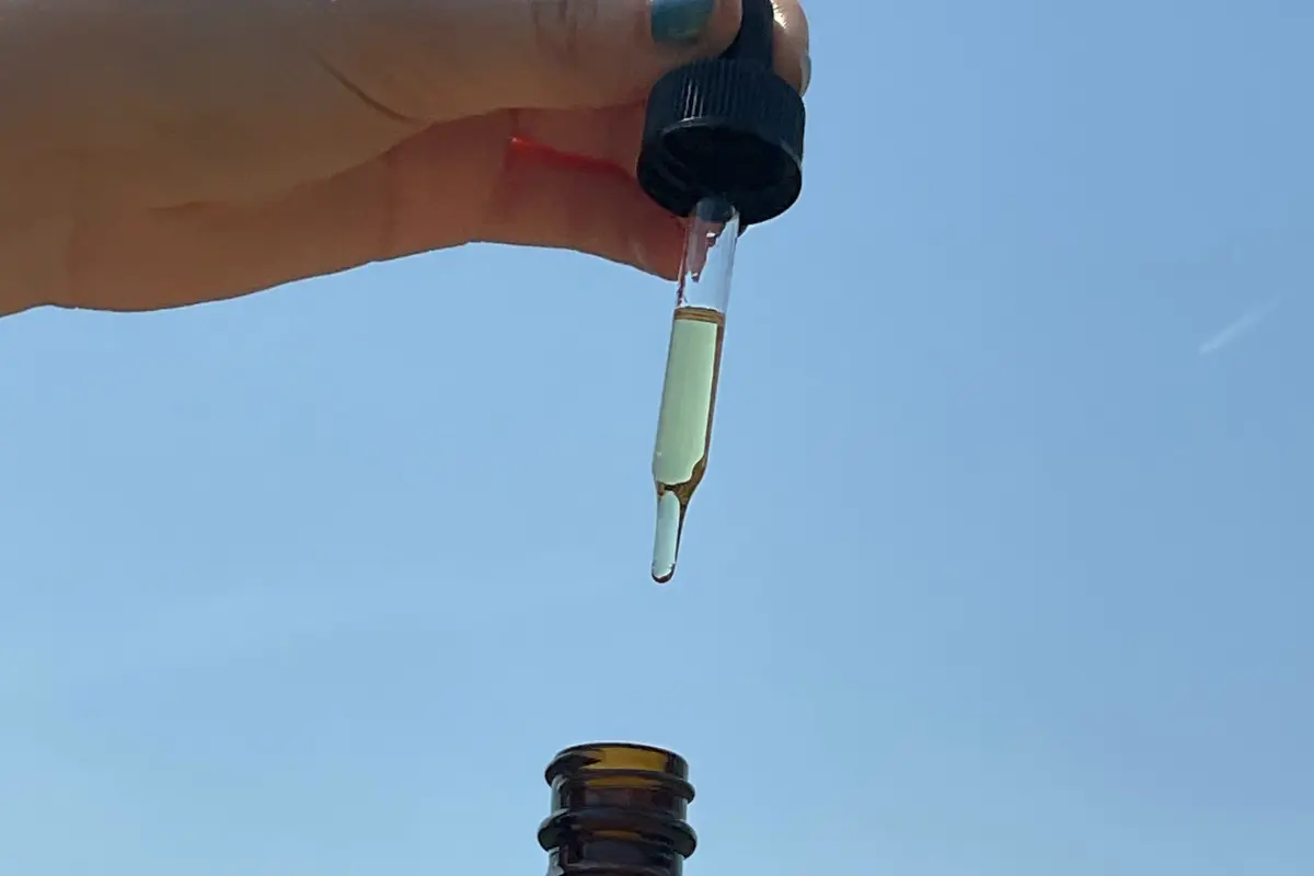 Natural Ways CBD oil tincture against blue sky