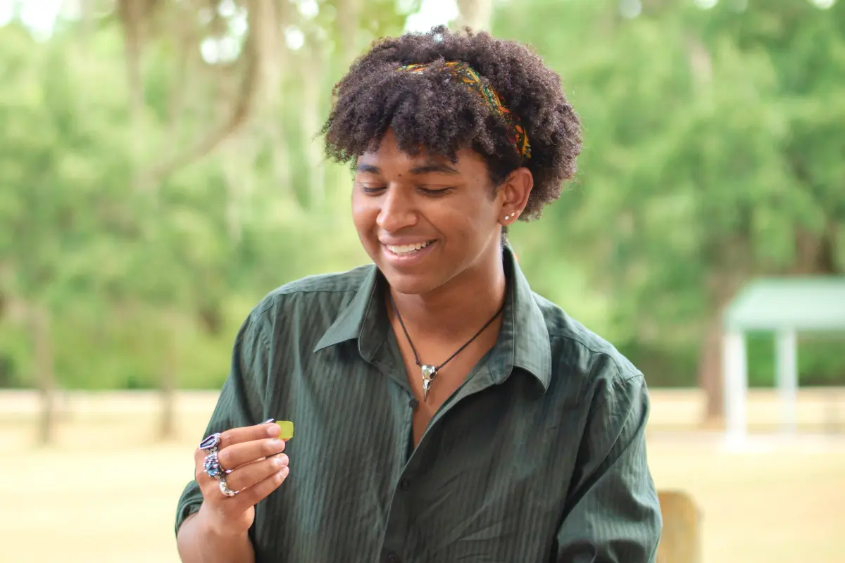 Young man outdoors eating CBD gummies